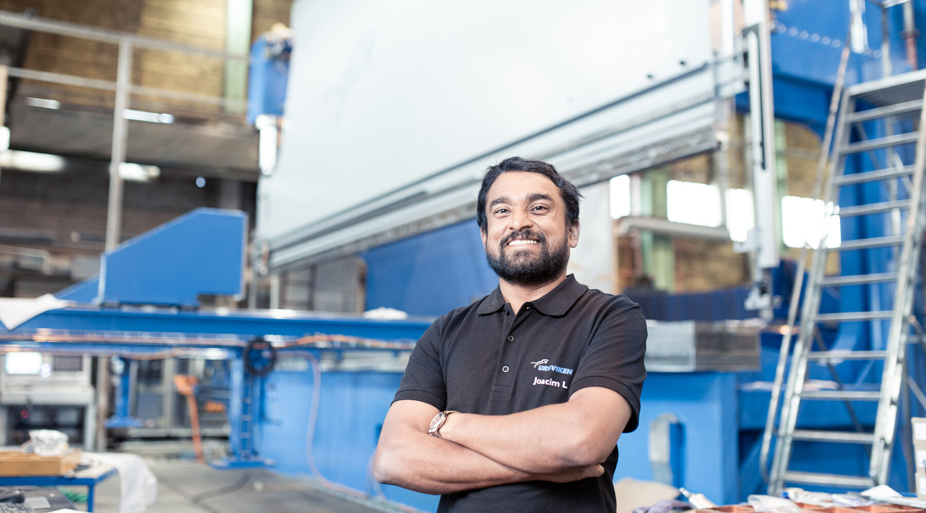 An employee in front of the presses